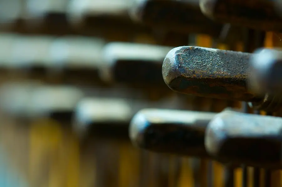 Close-up of piano tuning pins in the pin block